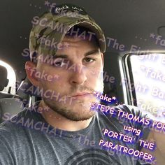 a man sitting in the back seat of a car wearing a camo hat and looking at the camera