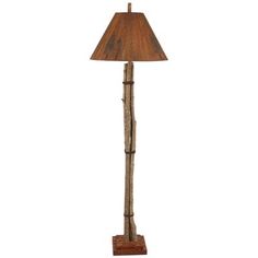 a lamp that is made out of wood and has a wooden base with a brown shade on