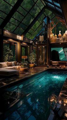 an indoor swimming pool is lit up with candles and lights in front of the tv