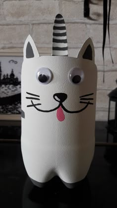 a paper mache with a cat face on it's head and tongue sticking out