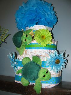 a diaper cake decorated with stuffed animals and flowers