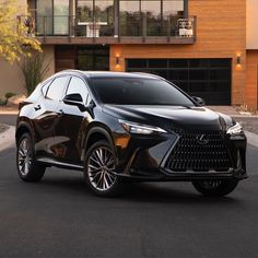 a black car parked in front of a house