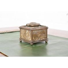 a small metal box sitting on top of a green mat