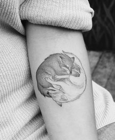 a black and white photo of a fox on the arm