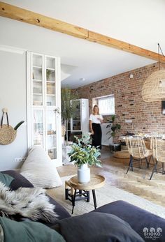 a woman is standing in the living room