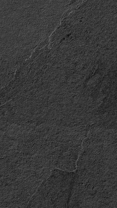 an image of a black surface that looks like it is made out of concrete