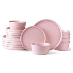 pink dishes and cups are stacked on top of each other