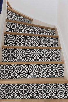 a stair case with black and white tiles on it