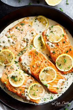 salmon with lemons and capers in a skillet ready to be served for dinner