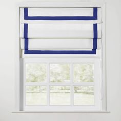 an open window with white and blue roman blinds