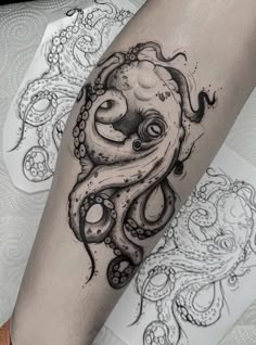 an octopus tattoo on the leg with black ink and white ink, it looks like he is