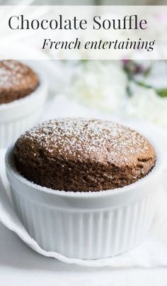 two chocolate souffles sitting on top of each other in small white dishes