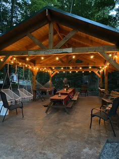 a covered patio with hammock chairs and lights