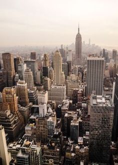 an aerial view of the city with skyscrapers and other tall buildings in the foreground