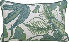 a green and white pillow with leaves on it