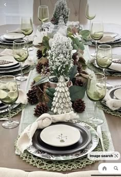 the table is set with dishes and place settings