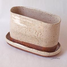 a ceramic cup and saucer sitting on a white surface