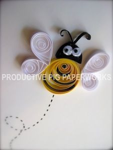 a paper sculpture of a bee on a white surface