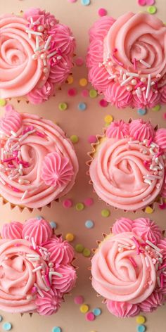 cupcakes decorated with pink frosting and sprinkles