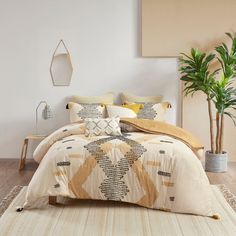 a bedroom with a large bed and potted plant