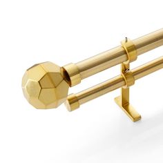 a pair of gold metal bars with a ball on each end and two poles attached to the ends