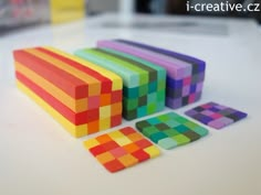 colorful wooden blocks sitting on top of a white table next to each other and the words i creative written above them