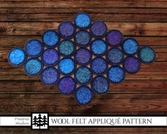 a blue and purple rug on top of a wooden floor with the words wool felt applique pattern