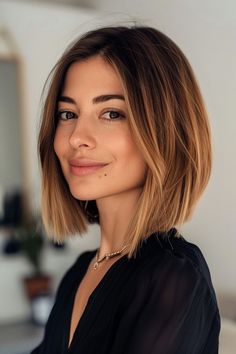 a close up of a person wearing a black shirt and smiling at the camera with her hand on her hip