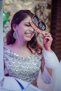 a woman holding up a sign that says don't to be married in front of her face