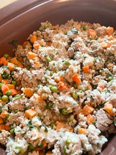 a bowl filled with meat and vegetables on top of a table