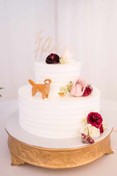 a white wedding cake with flowers on top