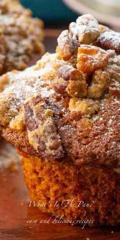 two muffins with powdered sugar on top