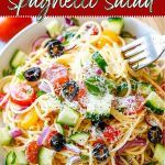 a bowl filled with pasta and vegetables on top of a wooden table