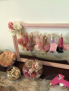 there are many items on the table and in front of the mirror that is hanging