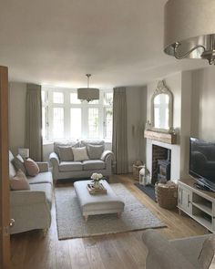 a living room filled with furniture and a fire place