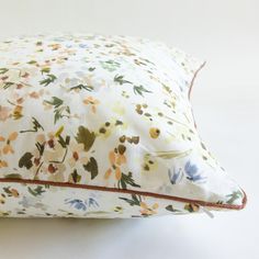 a white pillow with colorful flowers on it