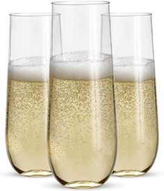 three glasses filled with champagne sitting next to each other