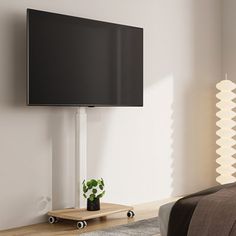 a flat screen tv mounted to the side of a wall next to a wooden bed