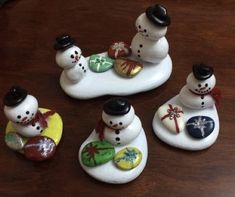 four snowmen sitting on top of each other