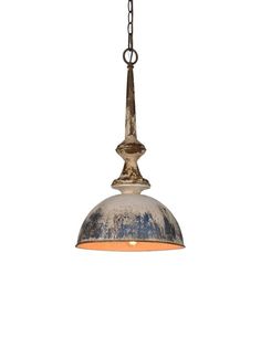 an old fashioned light hanging from a chain on a white wall with a rusted metal dome