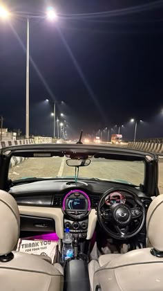 the interior of a car is lit up by street lamps and street lights at night