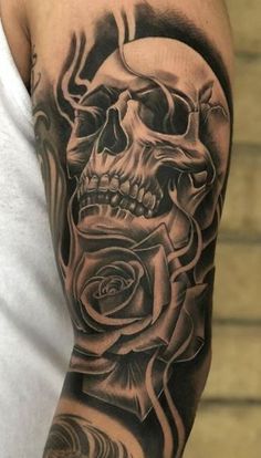 a man with a skull and rose tattoo on his arm