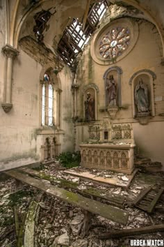 the interior of an abandoned church with stained glass windows and debris everywhere on the ground