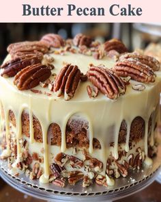 a cake with pecans and icing drizzled on top