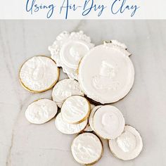 some white and gold coins are on the table with text overlay that reads, how to use air dry clay