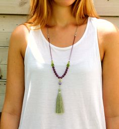 Simply stunning tassel necklace, made elegant by purple and olive green gemstones and finished with a long tassel. Add this statement necklace for that boho-chic touch to your look for any season. Handmade jewelry for you or your loved ones to enjoy wearing. Product Details: --------------------- Materials: *Czech beads *Silk tassel Measurements: Length of necklace: 30 inches / 76 cm. Length of tassel: 3.14 inches / 8 cm. Why purchase this Purple Tassel Necklace? Pretty and attractive jewelry pi Gift Beaded Dangle Tassel Necklace, Elegant Beaded Long Tassel Necklace, Bohemian Tassel Necklace With Colorful Beads, Adjustable Long Tassel Necklace With Colorful Beads, Bohemian Green Beaded Tassel Necklace, Tassel Necklace Boho, Gray Necklace, Beaded Tassel Necklace, Gemstone Necklace Pendant