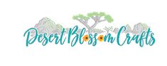 the desert blossom crafts logo is shown in blue and green letters with trees, mountains, and flowers