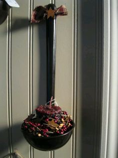 a cross hanging from the side of a wall next to a door with decorations on it