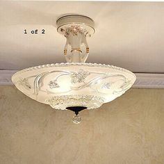 a ceiling light with an ornate design on the top and bottom part of it's fixture