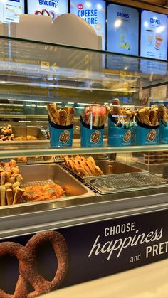 a display case filled with donuts and pretzels